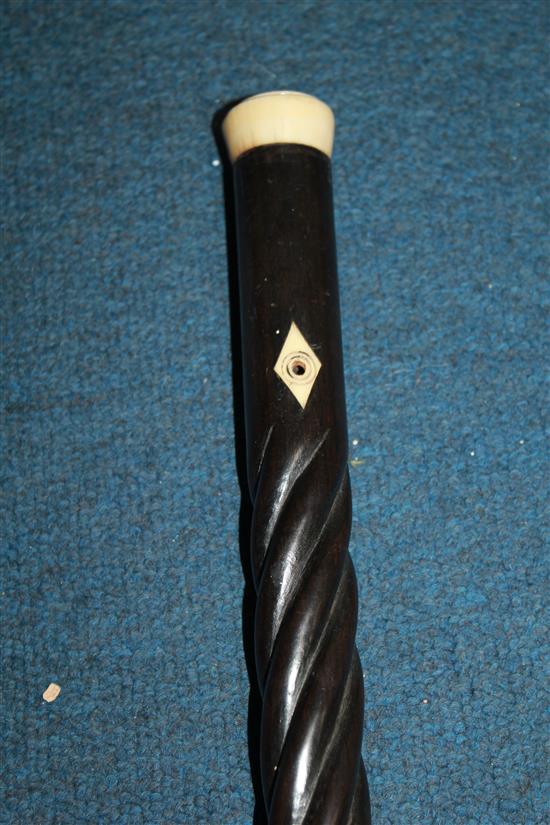 A late 19th / early 20th century ebony spiral twist turned walking cane, 37.25in.